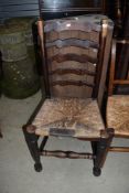 A traditional rush seated ladder back chair