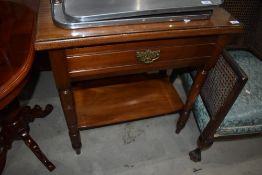 A Victorian mahogany side table/wash stand having frieze drawer on turned frame, with glass top