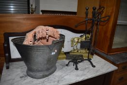 A pair of brass fire dogs, modelled as horses, a zinc coal helmet, a cast trivet and similar