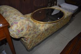 A traditional chaise longue having vintage yellow paisley cotton cover