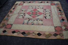 A large Victorian patchwork quilt, using various wool and wool blend fabrics, around a double in