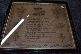 A needlework sampler or religious quote and floral decoration by Rachel Whitehead age 14 1847.