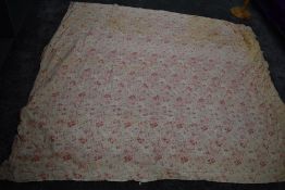 An early 20th century floral cotton bed throw,cotton wool filled, some age related wear.