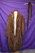 A vintage brown mink coat and tippet with feet and tales.