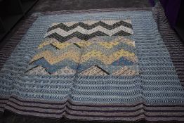 An unusual antique patchwork quilt,thought to be American,using bright floral cottons to the