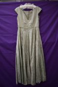 A 1940s pale green full length watered taffeta dress, having side hook and eye fastening.