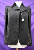 An early 20th century black wool jacket with cord detailing to front and cuffs,velvet collar,