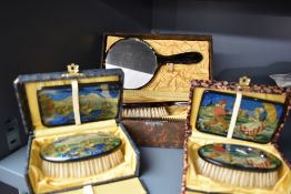 Two pretty vintage brush and mirror sets in boxes having Dutch scenes or similar, with transfers