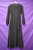A vintage 1930s sheer black over dress having balloon sleeves with ladder work detailing towards the