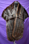 A dark brown mink stole having capstick and Hamer,Bradford and Morecambe label.