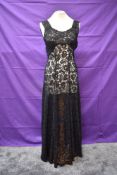 A black full length lace 1930s evening gown having half belt to back and full panelled skirt.