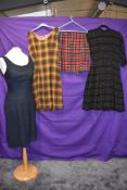 A collection of vintage clothing including 1950s wool dress, two late 50s/60s pinafores and a tartan
