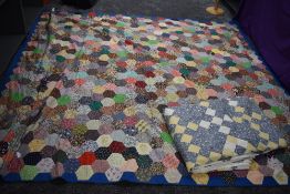 Two retro patchwork quilts, having vibrant floral fabrics used throughout.