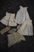 A selection of antique childrens items including a fine tulle lace apron and similar items,and