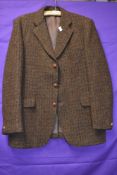 A vintage Harris tweed jacket in brown tones around late 60s/70s, pocket to sides and one to