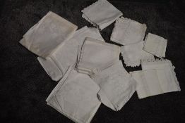 A selection of antique white work table linen including tray cloths,table cloths and more.