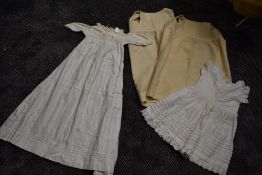 A small lot of early 20th century items,Two childrens wool petticoats or undergarments,a dress