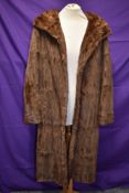 A vintage fur coat,thought to be ermine,having wide collar and Capstick and Hamer,Morecambe and