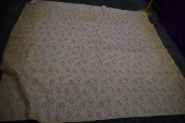 An early 20th century paisley cotton bed throw,cotton wool filled, some age related wear/staining.
