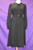 A 1930s/early 40s black textured crepe dress with belt to waist,bow to neckline and balloon