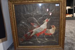 An antique gilt edged fire screen having framed embroidery in silk and metallic threads depicting