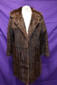 A vintage fur coat,thought to be ermine,having wide collar and Bainbridge and co, Newcastle label.