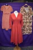 Three 1940s and 50s dresses including cherry red wool dress with honeycomb smocking.