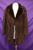 A late 1960s/70s Karakul lamb coat, with wide mink collar.