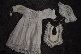 An antique chidrens gown with deep hem of cut work and embroidery ,drawstrings to cuffs and back,a