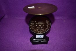 A small set of salter scales having brass face and wooden body.
