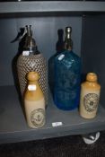 Two local Morecambe interest bottles and similar Soda Syphons one wire wrapped and similar Aqua Blue