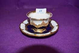 An antique tea cup and saucer set by Meissen having gold and cobalt decoration over white ground