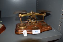 A set of antique brass post office scales reading Postal Rates for Letters with assortment of