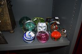 A selection of paper weights and glass dumps including lustre colour art and figural