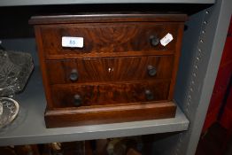 A miniature apprentice cabinet makers example of a chest of three drawers having flame mahogany