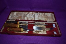 A vintage boxed horn handled carver set.
