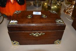A mahogany case tea caddy having brass edge work and banding with compartmental inner tins