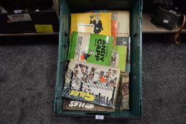 A box full of Andy Capp and Giles books.