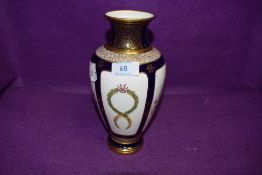 A hand decorated vase by Coalport Townsend having cobalt and gold having heir line crack to neck AF