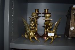 Two sets of heavy set candle sticks one copper and brass Arts Crafts styled pair with twisted stem