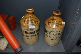 Two salt glazed advertising flagons for Black Beer Preston Meredith and Hawksley