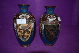 A pair of cloisonné vases depicting mythological beasts, flowers and more.