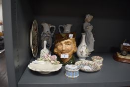 A selection of ceramics including Nao figurine Royal Doulton Robin hood jug and more.