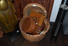 A selection of leather collar and wash bag cases in a woven fibre basket