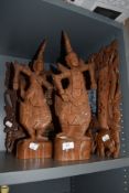 A selection of hand carved ethnic wood items including Indonesian styled figures and picture frames
