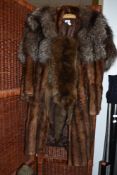 A brown mink coat a fox fur stole and a taxidermy fox wrap with head and feet