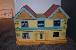 A GB Toys wooden two storey Dolls House named The Beeches, having tin plate windows with a selection