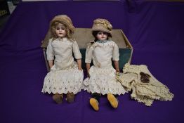 An early 20th century Ernst Heubach bisque headed doll having fixed open blue eyes, open mouth