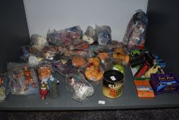 A shelf of modern toys and collectables including 1997 Mcdonalds toys, most in packets 1981 Ideal