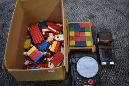 A selection of 1970/80's Lego including figures, a wooden block set, a Tomy 1979 Missile Strike